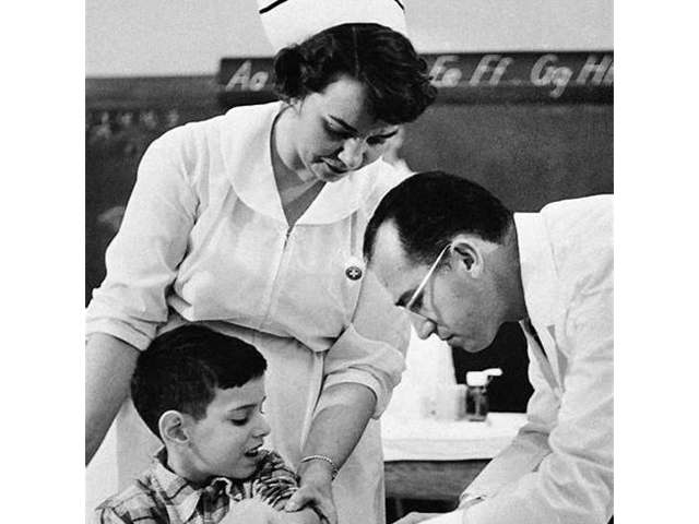 Doctor and nurse vaccinating boy